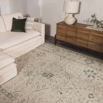 Living room scene with an off-white sofa and the Penkridge Sage Persian Style Rug in green and white. Roomscene-Rectangle