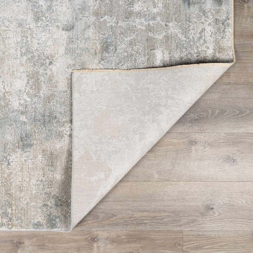 Close-up of the Pialba Thick Luxe Abstract Smokey Rug showing its dusty sage, blue, and gray abstract pattern and texture. Fold