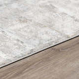 Close-up of the Pialba Thick Luxe Abstract Smokey Rug showing its light gray, taupe, and white abstract design. Corner