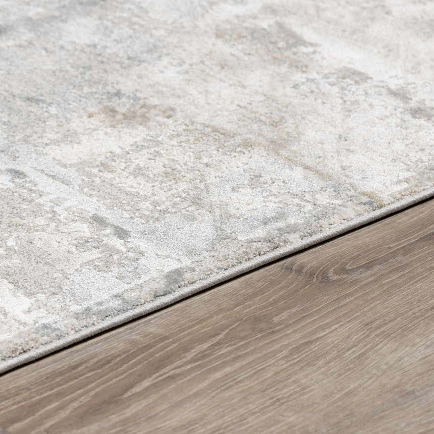 Close-up of the Pialba Thick Luxe Abstract Smokey Rug showing its light gray, taupe, and white abstract design. Corner