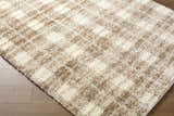 Close-up of the Anfisa Beige Luxe Shag Area Rug showing its cream and tan checkered pattern and soft, fluffy texture. Corner