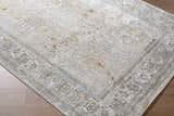Close-up of the Pryce Sage Thick Luxe Area Rug. Traditional rug with charcoal, cream, and light brown tones. Corner