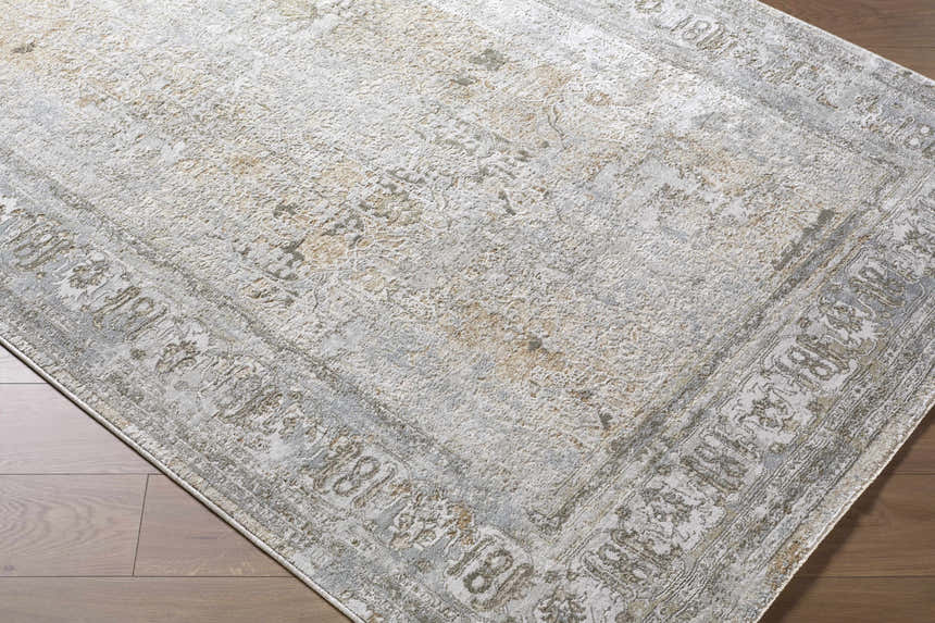 Close-up of the Pryce Sage Thick Luxe Area Rug. Traditional rug with charcoal, cream, and light brown tones. Corner
