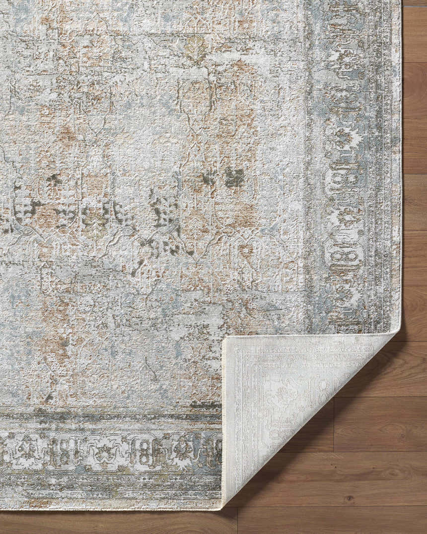 Close-up of Pryce Sage Thick Luxe Area Rug showing charcoal, cream, brown, and gray traditional pattern and folded corner. Fold