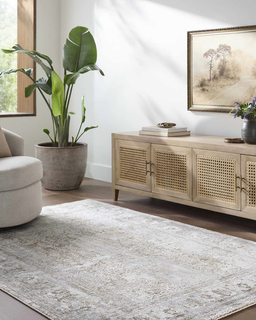 Living room scene with Pryce Sage Thick Luxe Area Rug, beige swivel chair, and light wood media console. Roomscene-Rectangle
