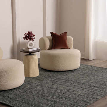Living room scene with round chairs on the Olisa Charcoal Wool Area Rug. Modern neutral decor. Roomscene-Rectangle