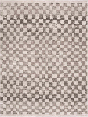Close-up of the Benjy Irregular Checkboard Rug. Beige, cream, and tan squares create a geometric, mid-century modern pattern. Design-Rectangle-46