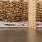 Close-up of the Priscilla Area Rug showing the pile height with a ruler, plus a woven basket. Pile