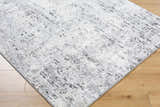 Close-up of the Avital Area Rug. Contemporary design in black, charcoal, gray, and white on a machine woven rectangle. Corner