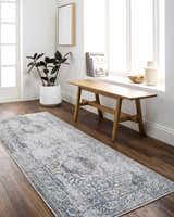 Entryway with Annlea Washable Area Rug in blue and sage, wood bench, potted plant, and bright natural light. Roomscene-Runner