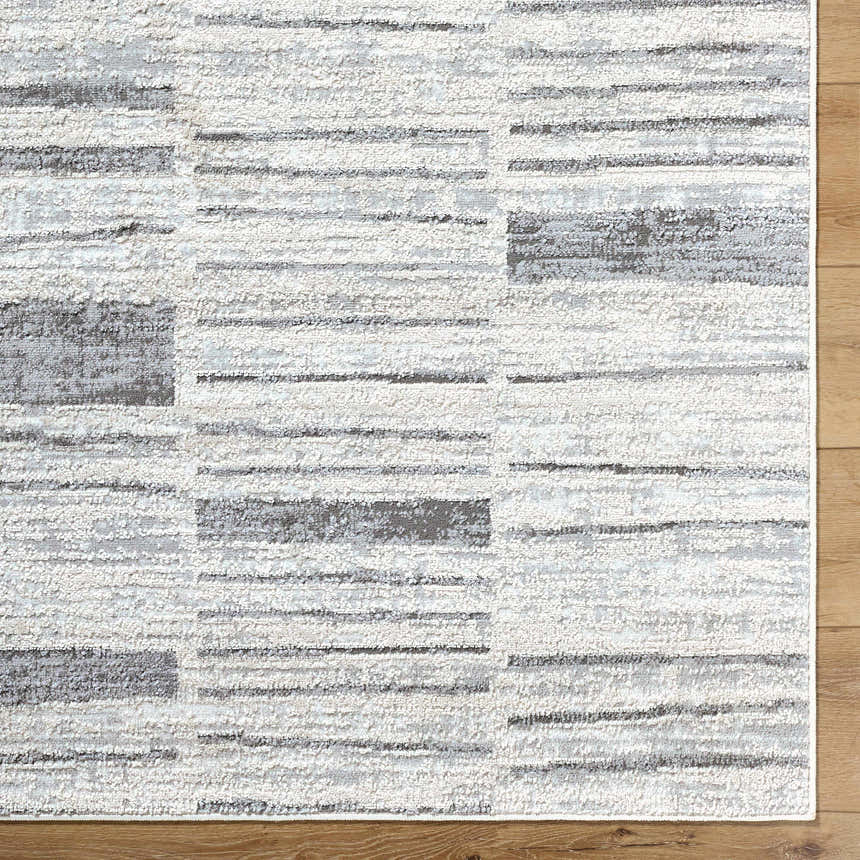 Close-up of Allete Broken-Striped Area Rug showing its ash, light silver, and silver gray contemporary design. Corner