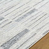 Close-up of the Allete Broken-Striped Area Rug. Ash, light silver, and silver gray broken stripe design. Contemporary style. Texture