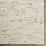 Close-up of the hand-tufted Aintza Area Rug. Beige, cream, ivory, and tan wool rug with a geometric pattern. Farmhouse style. Corner