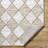 Close-up of the Aideen Cream Shag Area Rug showing diamond pattern and texture. Colors are cream, gray, and light brown. Fold