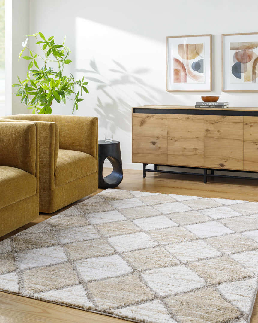 Living room scene with gold armchairs and Aideen Cream Shag Area Rug featuring a diamond pattern. Roomscene-Rectangle