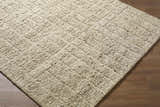 Close-up of the Asahel Ivory Area Rug. Hand-tufted wool rug with a textured, geometric pattern. Farmhouse, transitional style. Corner