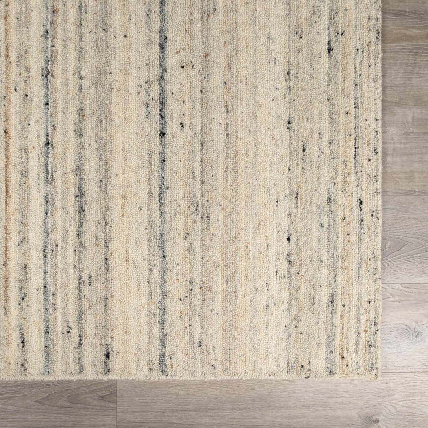 Close-up of the Capote Ivory Area Rug. Hand-tufted wool rug with charcoal, tan, and taupe vertical stripes. Swatch