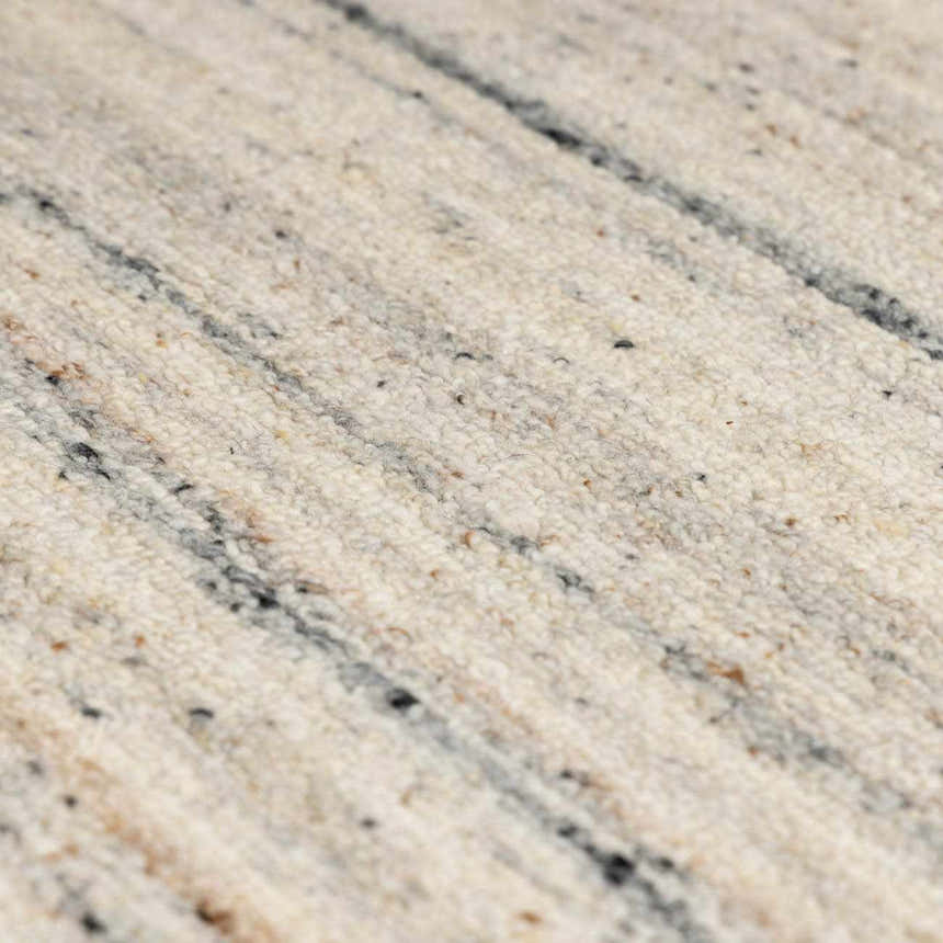 Close-up of the hand-tufted Capote Ivory Area Rug showing wool texture and subtle charcoal, tan, and taupe stripes. Texture