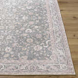 Close up of the Anando Washable Area Rug. Machine woven rug with a traditional floral pattern in cream, green, and pale pink. Front