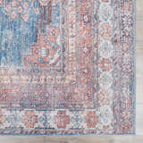 Close-up of the Baltinglass Rust & Blue Washable Area Rug, showing its traditional floral pattern and distressed texture. Swatch