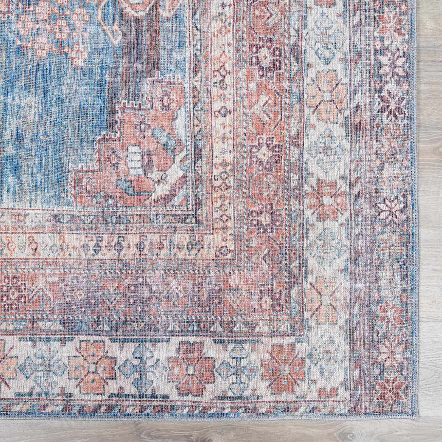 Close-up of the Baltinglass Rust & Blue Washable Area Rug, showing its traditional floral pattern and distressed texture. Swatch