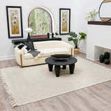Living room scene with ivory Ramsbury Wool Area Rug, cream chaise lounge, and black accents. Roomscene-Rectangle