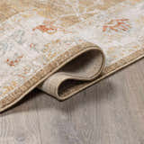 Close-up of the Rangeville Thick Luxe Statement Rug showing its brown, orange, and cream traditional pattern and woven texture. Fold
