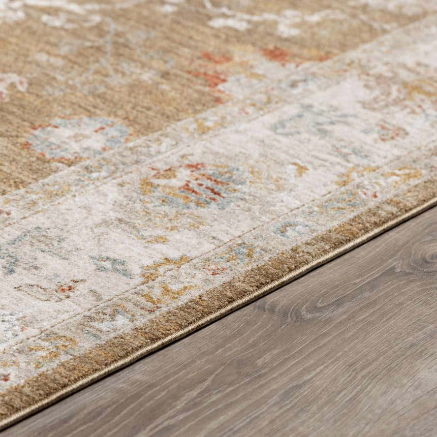 Close-up of the Rangeville Thick Luxe Statement Rug. Features brown, orange, and blue traditional patterns. Pile