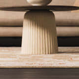 Close-up of the beige Rangeville Thick Luxe Statement Rug with a subtle orange pattern under a modern coffee table. Styleshot