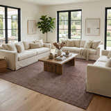 Living room scene with neutral sofas and Leanna Light Brown Washable Area Rug on hardwood floors. Roomscene-Rectangle