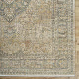 Close-up of the beige, tan, and brown floral pattern on the Becki Beige Owens x Livabliss Renaissance Area Rug. Corner