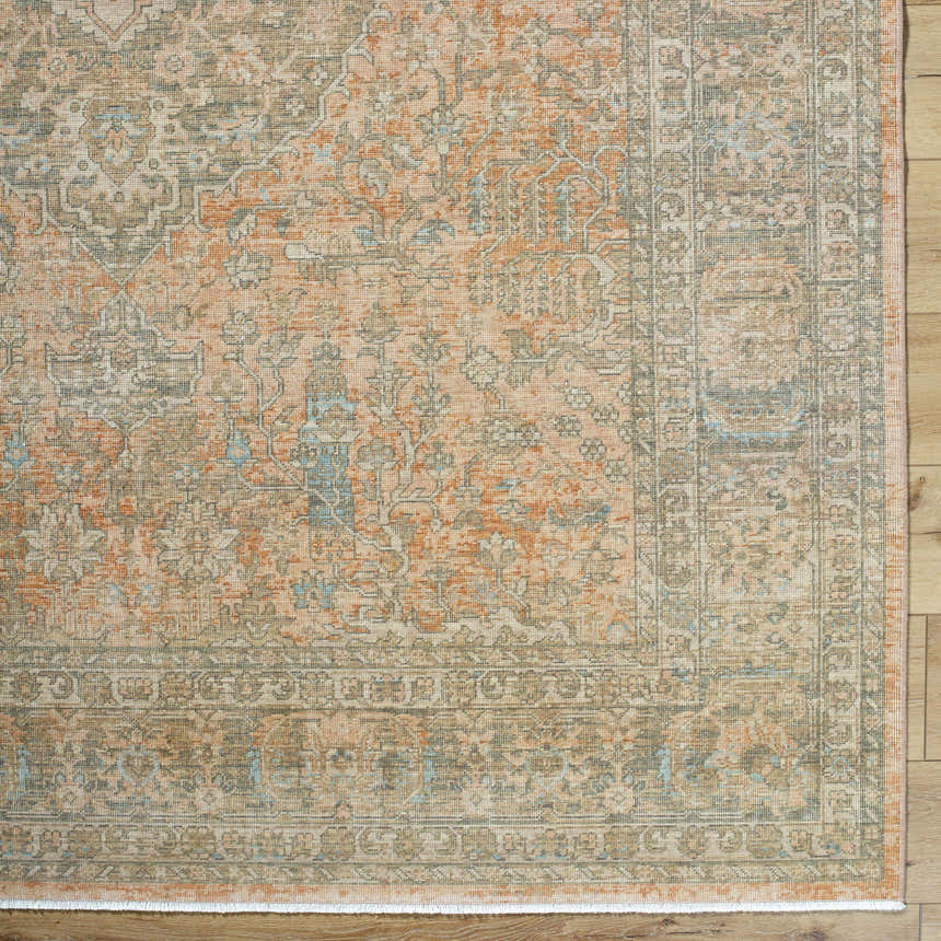 Close-up of Becki Owens x Livabliss Renaissance BORI-2301 rug. Hand-crafted wool rug in beige, denim, coral, tan, and taupe. Corner