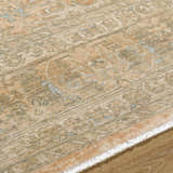 Close-up of the hand-crafted Becki Owens x Livabliss Renaissance BORI-2301 rug. Beige, denim, coral, and tan traditional pattern. Texture