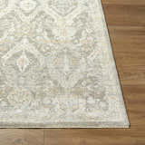 Close-up of Almaas Medium Gray rug showing traditional floral pattern and luxe texture on wood floor. Front