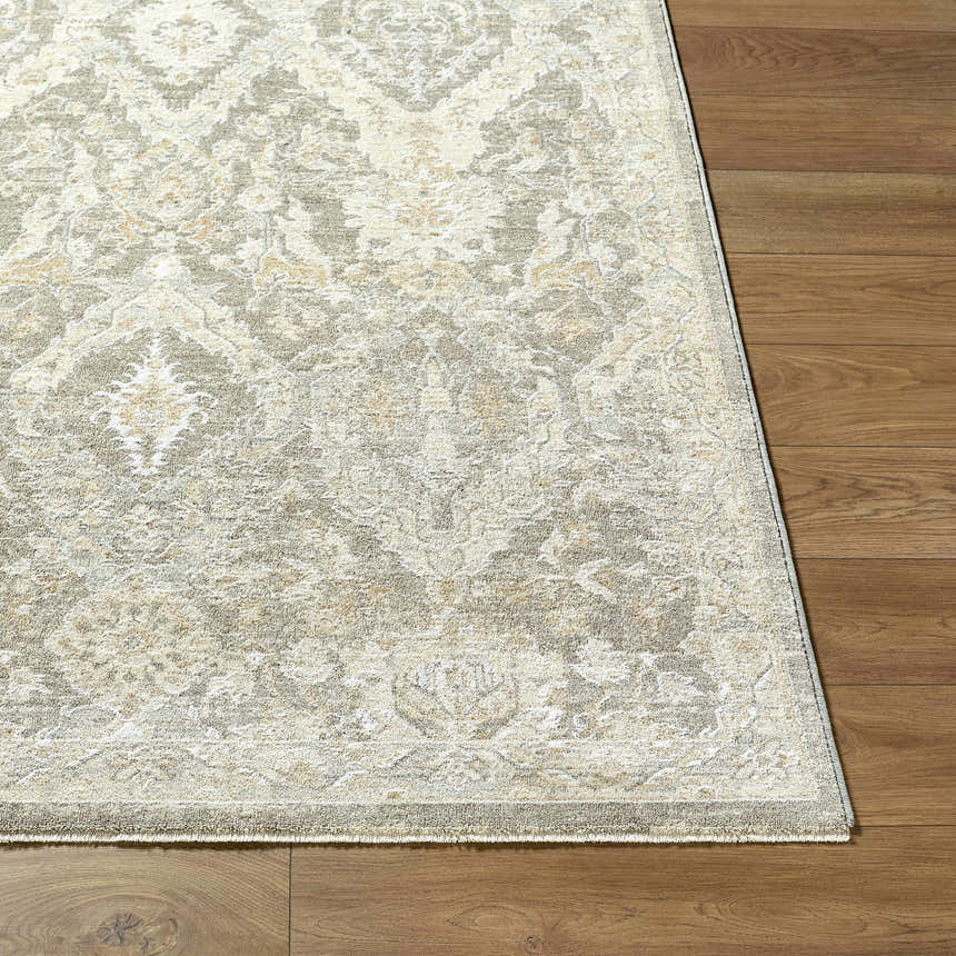Close-up of Almaas Medium Gray rug showing traditional floral pattern and luxe texture on wood floor. Front