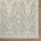 Close-up of the Almaas Medium Gray rug showing its traditional floral pattern and soft texture on a wood floor. Corner