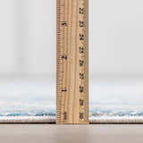Close-up of the Rydalmere Rug pile height, showing its soft texture and light blue pattern with a ruler for scale. Pile