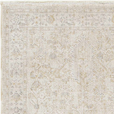 Close-up of the Rafee Tan Luxe Area Rug, showcasing its traditional pattern and soft cream, tan, and gray colors. Texture