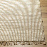 Close-up of the Mihal Area Rug, a hand-woven jute rug in beige and light beige with a traditional, farmhouse style. Front