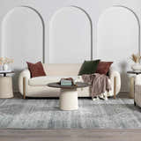 Living room scene with a Barny Gray Blue Washable Rug, cream sofa, round tables, and arched wall decor. Modern farmhouse style. Roomscene-Rectangle
