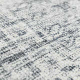 Close-up of the Barny Gray Blue Washable Rug showing its charcoal and off-white distressed pattern and soft chenille texture. Texture
