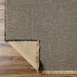 Close-up of the Kimi Machine Woven Becki Owens x LIVABLISS rug. Black and light brown jute with a grid pattern and fringed edge. Fold