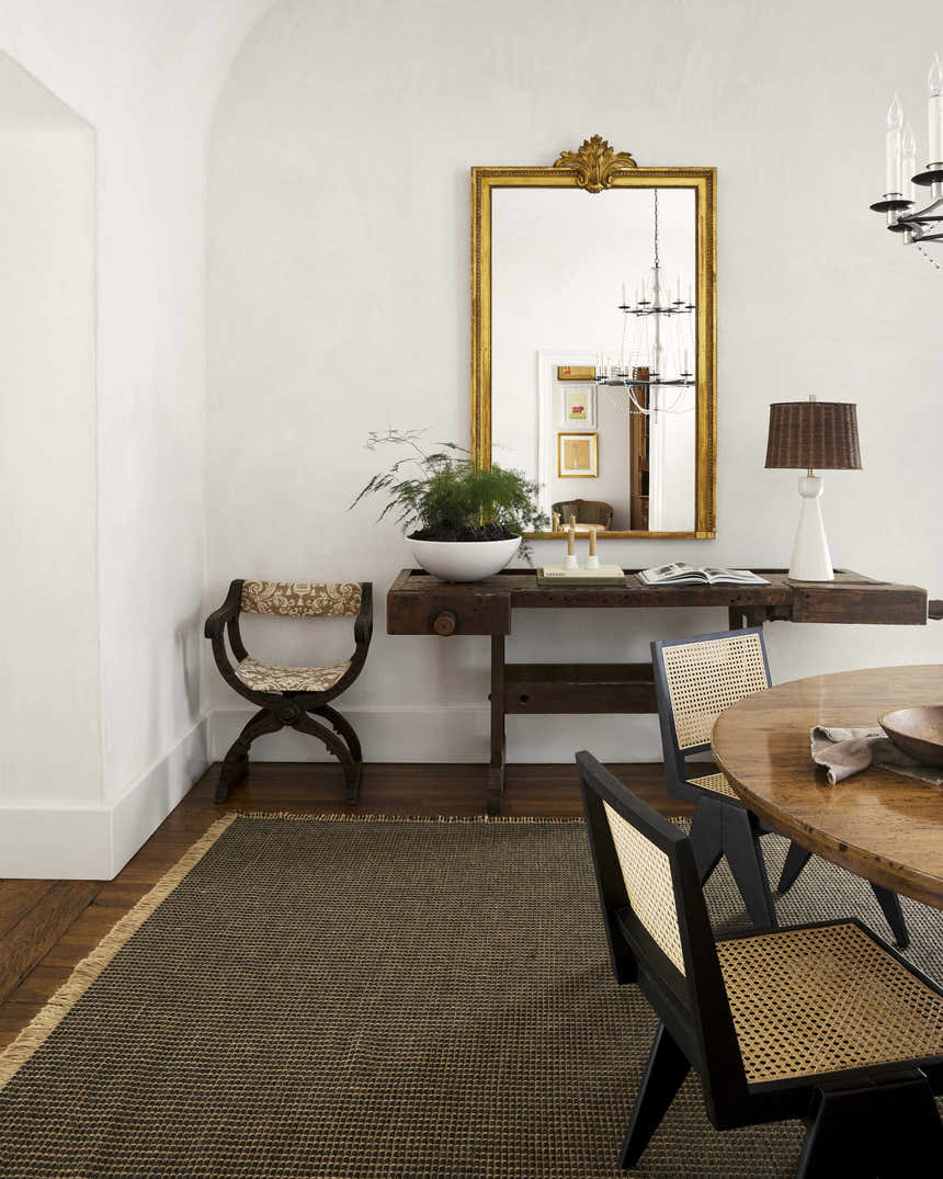 Farmhouse dining room with Kimi Machine Woven Becki Owens x LIVABLISS rug, wood table, and gold mirror. Styleshot