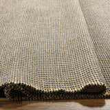 Close-up of Kimi Machine Woven Becki Owens x LIVABLISS rug. Black and light brown jute texture, machine woven. Texture