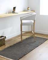 Minimalist office scene with Kimi Machine Woven Becki Owens x LIVABLISS rug in black and light brown. Roomscene-Runner