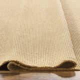 Close-up of the light brown Kimi Machine Woven Becki Owens x LIVABLISS area rug showing texture and jute material. Texture