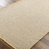 Close-up of the Kimi Machine Woven Becki Owens x LIVABLISS rug. Tan and gray jute texture with a farmhouse style. Corner