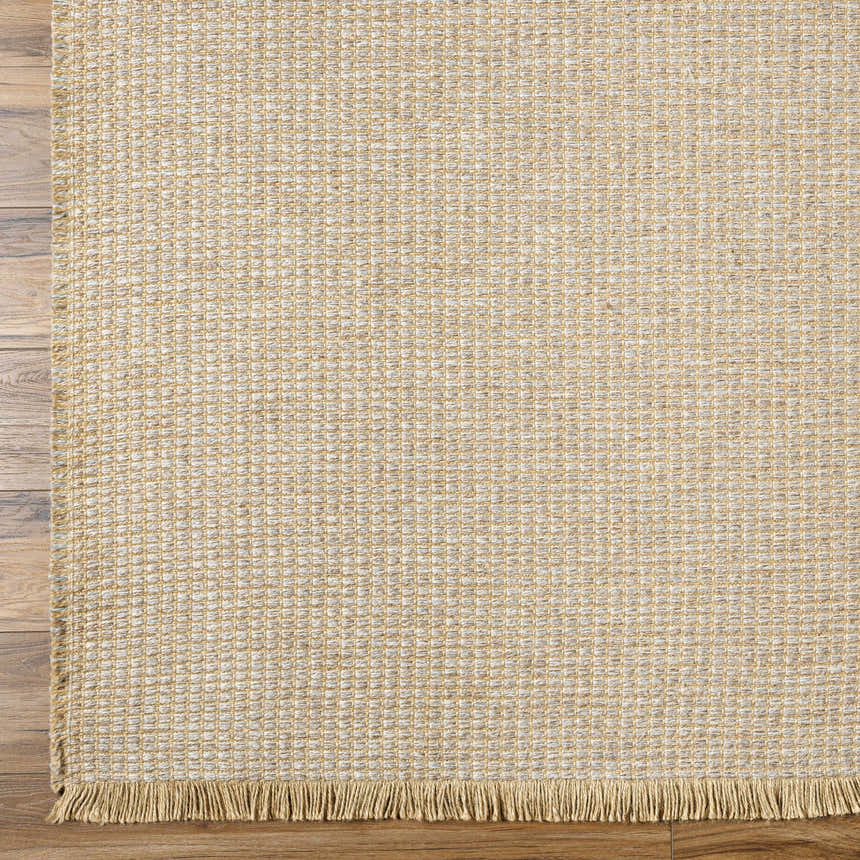 Close-up of the Kimi Machine Woven Becki Owens x LIVABLISS BOKM-2306 Area Rug. Tan and light brown jute texture. Corner