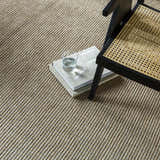 Close up of the Kimi Machine Woven Becki Owens x LIVABLISS rug showing texture and gray, light brown, and tan colors. Styleshot