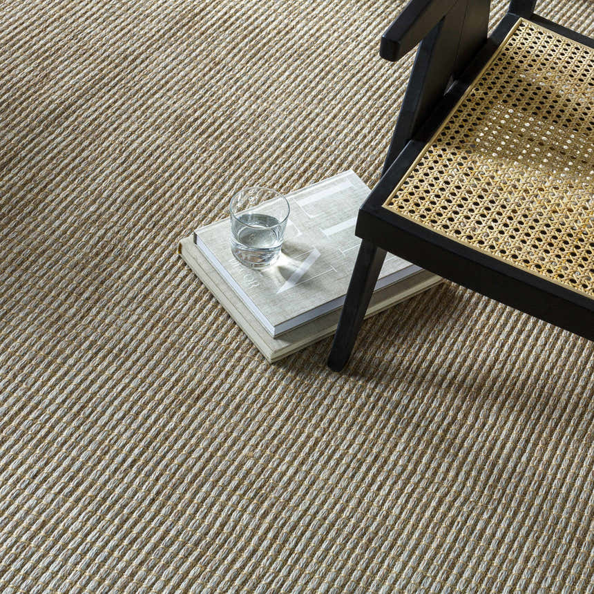 Close up of the Kimi Machine Woven Becki Owens x LIVABLISS rug showing texture and gray, light brown, and tan colors. Styleshot